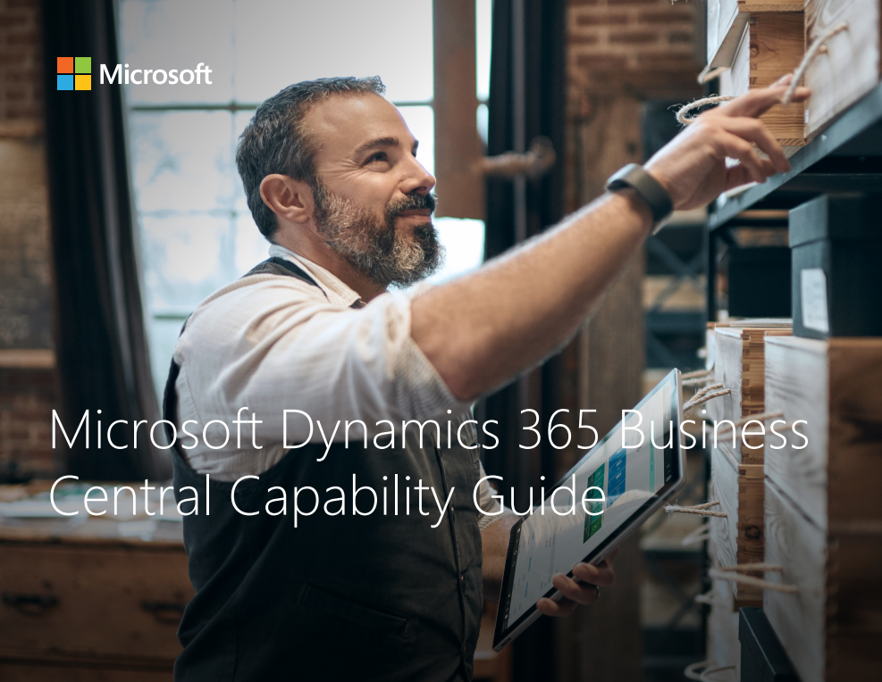 Man using a tablet to manage inventory in a warehouse, promoting Microsoft Dynamics 365 Business Central Capability Guide.